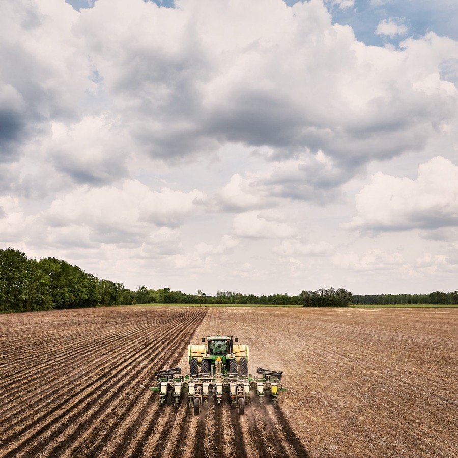 A farmer planting a field for the growing season